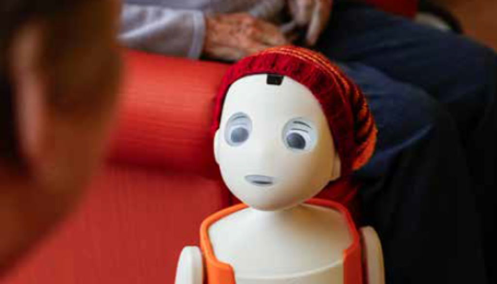 Pflegeroboter Oscar redet mit einer Seniorin.