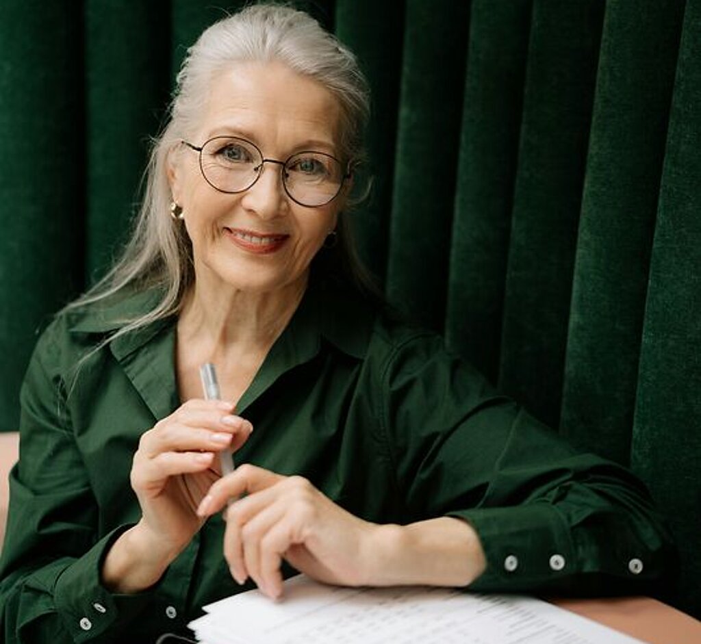 Eine Frau mittleren Alters füllt ein Formular aus.